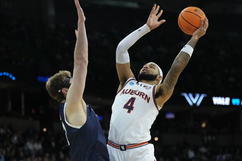 Mar 22, 2024; Spokane, WA, USA; Auburn Tigers forward Johni Broome (4) attempts a basket against Yale Bulldogs forward Danny Wolf (1) during the first half of a game in the first round of the 2024 NCAA Tournament at Spokane Veterans Memorial Arena. Mandatory Credit: Kirby Lee-USA TODAY Sports 