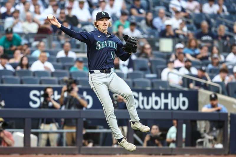 May 22, 2024; Bronx, New York, USA;  Seattle Mariners starting pitcher Bryce Miller (50) attempts to throw a runner out in the first inning against the New York Yankees at Yankee Stadium. Mandatory Credit: Wendell Cruz-USA TODAY Sports