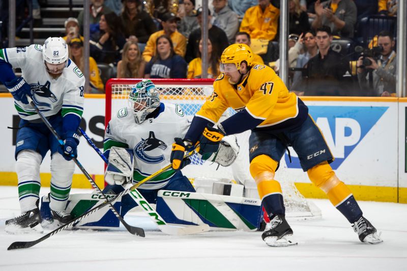 May 3, 2024; Nashville, Tennessee, USA; Vancouver Canucks goalkeeper Vancouver Canucks goalie Arturs Silovs (31) blocks the hot tof Vancouver Canucks defenseman Noah Juulsen (47) during the first period in game six of the first round of the 2024 Stanley Cup Playoffs at Bridgestone Arena. Mandatory Credit: Steve Roberts-USA TODAY Sports