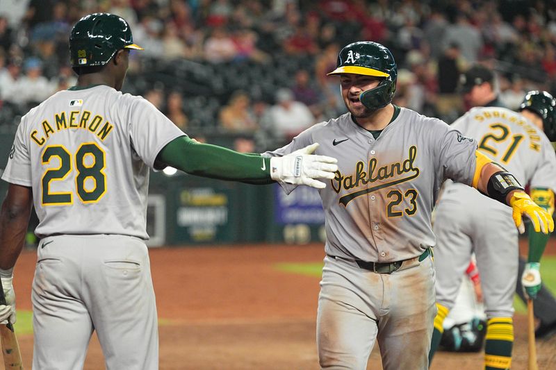 Jun 28, 2024; Phoenix, Arizona, USA; Oakland Athletics catcher Shea Langeliers (23) celebrates with outfielder Daz Cameron (28) after hitting a home run in the eighth inning against Arizona Diamondbacks at Chase Field. Mandatory Credit: Allan Henry-USA TODAY Sports