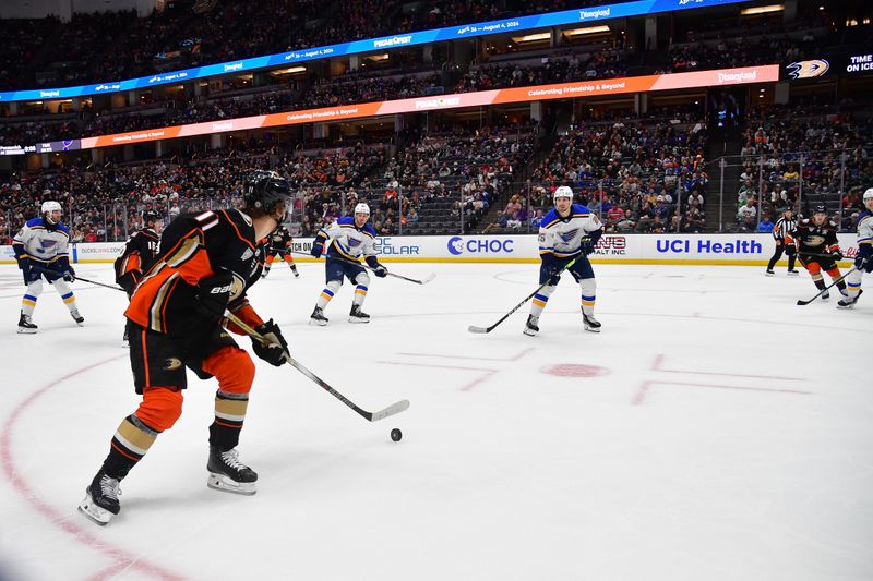 Apr 7, 2024; Anaheim, California, USA; Anaheim Ducks center Trevor Zegras (11) moves the puck against the St. Louis Blues during the second period at Honda Center. Mandatory Credit: Gary A. Vasquez-USA TODAY Sports