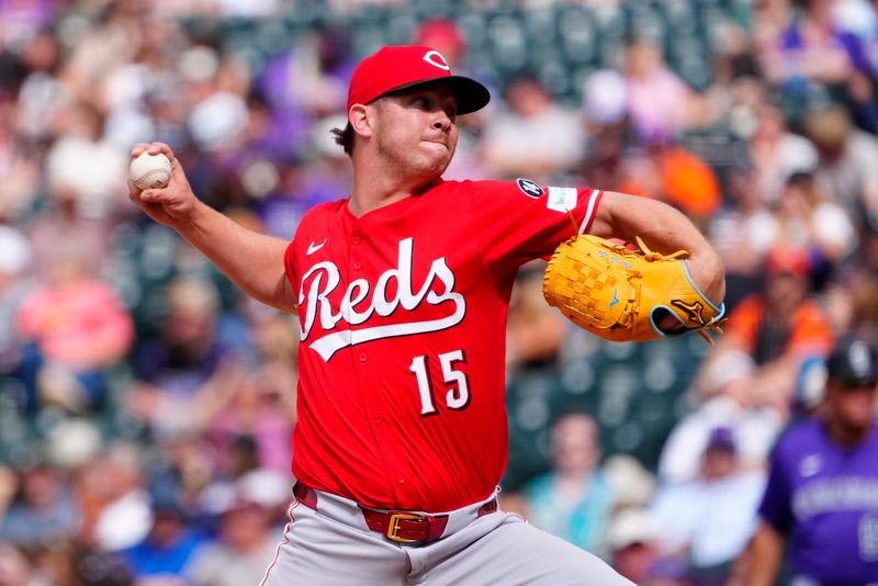 Apr 26, 2025; Denver, Colorado, USA; Cincinnati Reds relief pitcher Emilio Pagan (15) delivers a pitch in the ninth inning against the Colorado Rockies at Coors Field. Mandatory Credit: Ron Chenoy-Imagn Images