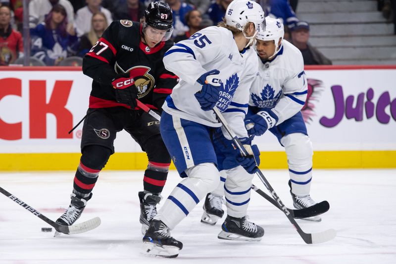 Feb 10, 2024; Ottawa, Ontario, CAN; Ottawa Senators leftwing Parker Kelly (27) loses sight of the puck as he battles with Toronto Maple Leafs defenseman Willian Lagesson (85) and right wing Ryan Reaves (75) in the first period at the Canadian Tire Centre. Mandatory Credit: Marc DesRosiers-USA TODAY Sports