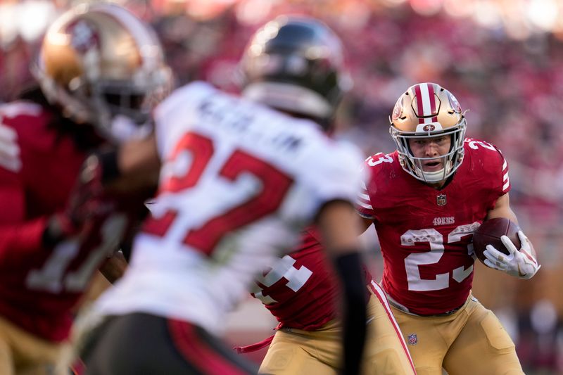 San Francisco 49ers running back Christian McCaffrey, right, runs with the ball against the Tampa Bay Buccaneers during the second half of an NFL football game Sunday, Nov. 19, 2023, in Santa Clara, Calif. (AP Photo/Godofredo A. Vásquez)