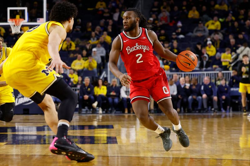 Jan 15, 2024; Ann Arbor, Michigan, USA; Ohio State Buckeyes guard Bruce Thornton (2) dribbles while defended by Michigan Wolverines forward Olivier Nkamhoua (13) in the second half at Crisler Center. Mandatory Credit: Rick Osentoski-USA TODAY Sports