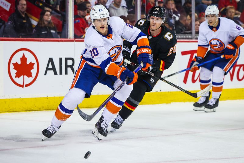 Nov 18, 2023; Calgary, Alberta, CAN; New York Islanders right wing Hudson Fasching (20) passes the puck against the Calgary Flames during the second period at Scotiabank Saddledome. Mandatory Credit: Sergei Belski-USA TODAY Sports