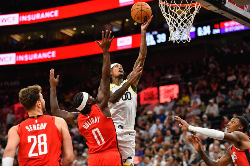 SALT LAKE CITY, UTAH - OCTOBER 07: Jordan Clarkson #00 of the Utah Jazz shoots over Aaron Holiday #0 of the Houston Rockets during the first half of a preseason game at Delta Center on October, 7 2024 in Salt Lake City, Utah. NOTE TO USER: User expressly acknowledges and agrees that, by downloading and or using this photograph, User is consenting to the terms and conditions of the Getty Images License Agreement. (Photo by Alex Goodlett/Getty Images)