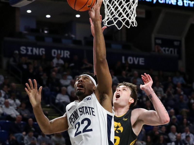 Jan 1, 2023; University Park, Pennsylvania, USA; Penn State Nittany Lions guard Jalen Pickett (22) drives the ball to the basket as Iowa Hawkeyes forward Patrick McCaffery (22) defends during the first half at Bryce Jordan Center. Mandatory Credit: Matthew OHaren-USA TODAY Sports