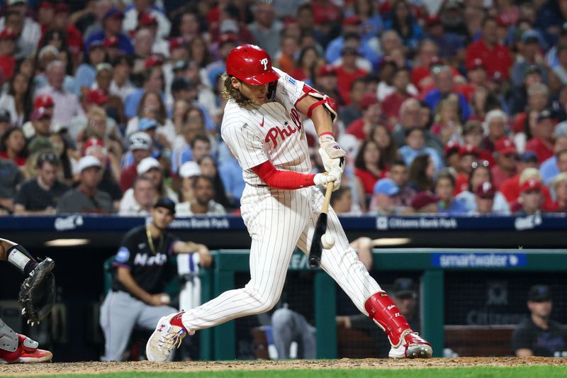 Aug 14, 2024; Philadelphia, Pennsylvania, USA; Philadelphia Phillies third base Alec Bohm (28) hits an RBI single during the seventh inning against the Miami Marlins at Citizens Bank Park. Mandatory Credit: Bill Streicher-USA TODAY Sports