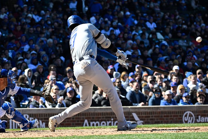 Apr 5, 2024; Chicago, Illinois, USA;  Los Angeles Dodgers two-way player Shohei Ohtani (17) hits a two-run home run against the Chicago Cubs during the fifth inning at Wrigley Field. Mandatory Credit: Matt Marton-USA TODAY Sports