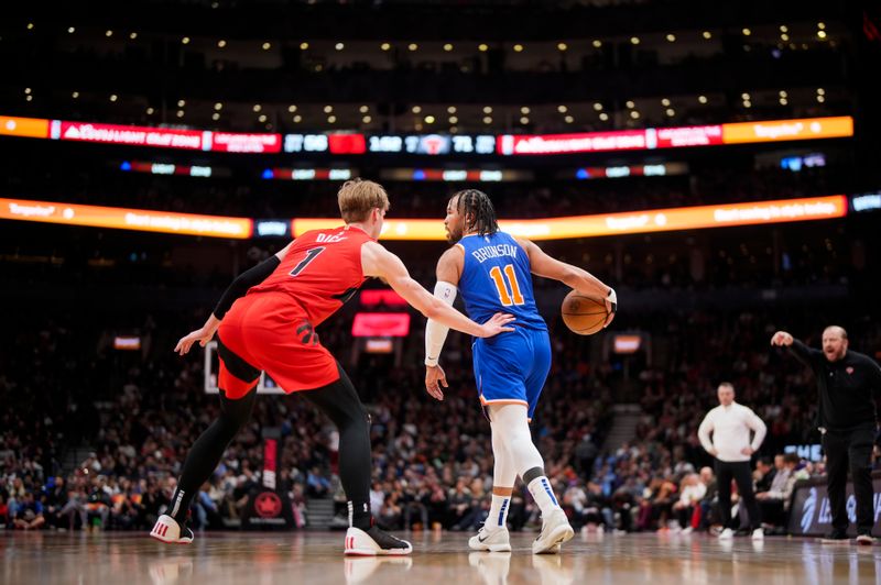 TORONTO, ON - MARCH 27: Jalen Brunson #11 of the New York Knicks dribbles against Gradey Dick #1 of the Toronto Raptors during the first half of their basketball game at the Scotiabank Arena on March 27, 2024 in Toronto, Ontario, Canada. NOTE TO USER: User expressly acknowledges and agrees that, by downloading and/or using this Photograph, user is consenting to the terms and conditions of the Getty Images License Agreement. (Photo by Mark Blinch/Getty Images)