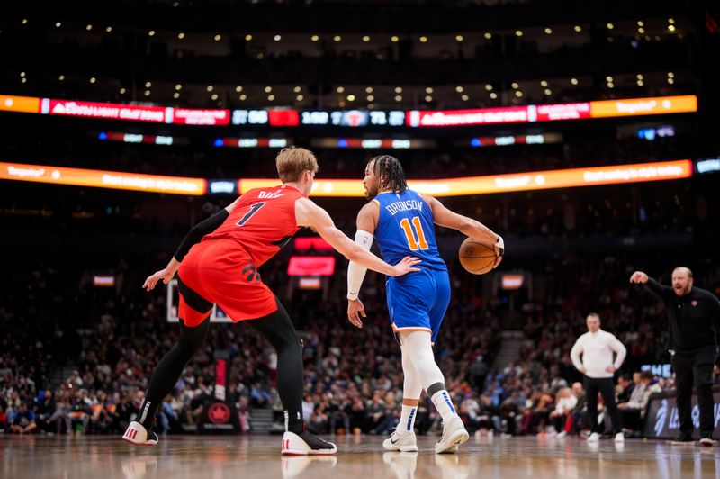 TORONTO, ON - MARCH 27: Jalen Brunson #11 of the New York Knicks dribbles against Gradey Dick #1 of the Toronto Raptors during the first half of their basketball game at the Scotiabank Arena on March 27, 2024 in Toronto, Ontario, Canada. NOTE TO USER: User expressly acknowledges and agrees that, by downloading and/or using this Photograph, user is consenting to the terms and conditions of the Getty Images License Agreement. (Photo by Mark Blinch/Getty Images)