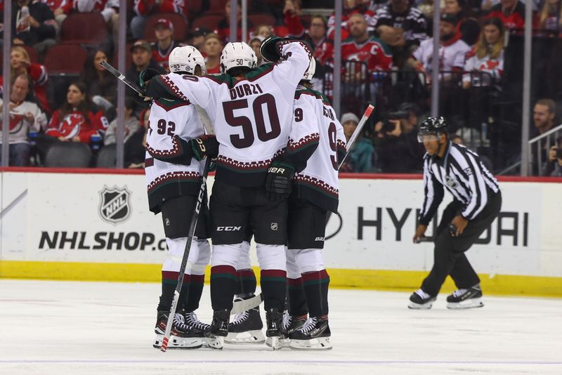 Oct 13, 2023; Newark, New Jersey, USA; Arizona Coyotes defenseman Sean Durzi (50) celebrates his goal against the New Jersey Devils during the second period at Prudential Center. Mandatory Credit: Ed Mulholland-USA TODAY Sports