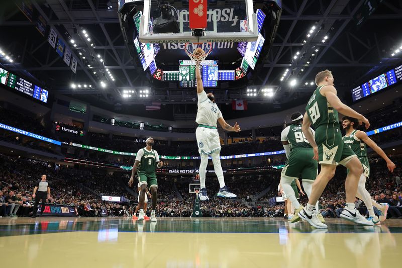 MILWAUKEE, WISCONSIN - FEBRUARY 08: Karl-Anthony Towns #32 of the Minnesota Timberwolves dunks against the Milwaukee Bucks during a game at Fiserv Forum on February 08, 2024 in Milwaukee, Wisconsin. NOTE TO USER: User expressly acknowledges and agrees that, by downloading and or using this photograph, User is consenting to the terms and conditions of the Getty Images License Agreement. (Photo by Stacy Revere/Getty Images)