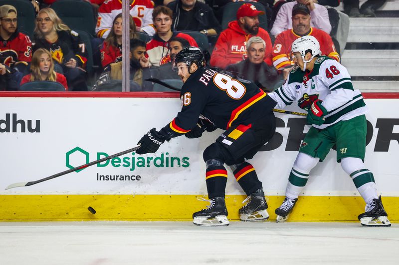 Dec 4, 2025; Calgary, Alberta, CAN; Calgary Flames left wing Joel Farabee (86) controls the puck against Minnesota Wild defenseman Jared Spurgeon (46) during the first period at Scotiabank Saddledome. Mandatory Credit: Sergei Belski-Imagn Images