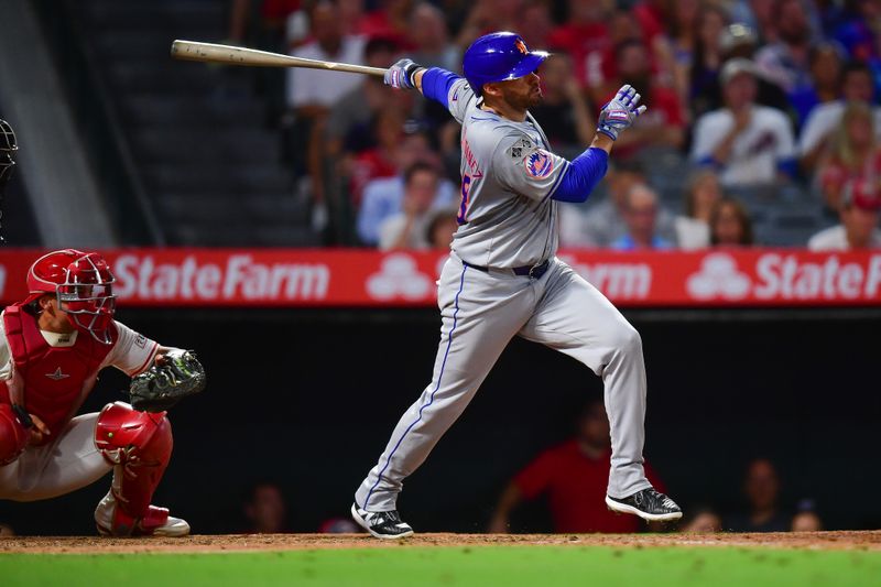 August 3, 2024; Anaheim, California, USA; New York Mets designated hitter J.D. Martinez (28) hits a grand slam home run against the Los Angeles Angels during the seventh inning at Angel Stadium. Mandatory Credit: Gary A. Vasquez-USA TODAY Sports