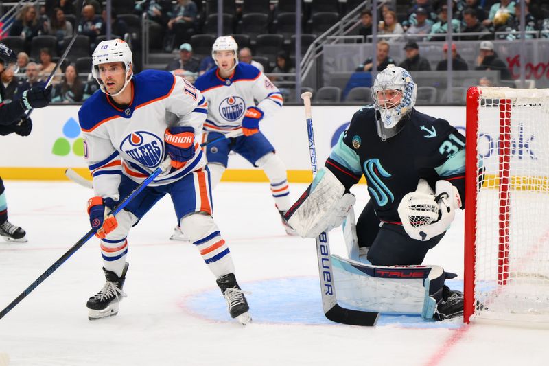 Oct 2, 2024; Seattle, Washington, USA; Seattle Kraken goaltender Philipp Grubauer (31) defends the goal next from Edmonton Oilers center Derek Ryan (10) during the second period at Climate Pledge Arena. Mandatory Credit: Steven Bisig-Imagn Images