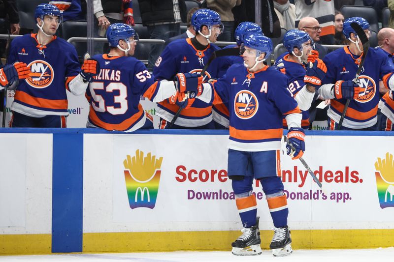 Jan 16, 2025; Elmont, New York, USA;  New York Islanders center Bo Horvat (14) celebrates after scoring a goal in the first period against the Philadelphia Flyers at UBS Arena. Mandatory Credit: Wendell Cruz-Imagn Images