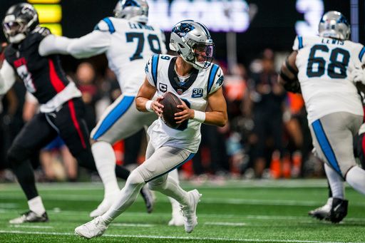 Carolina Panthers quarterback Bryce Young (9) rolls out during the first half of an NFL football game against the Atlanta Falcons, Sunday, Jan. 5, 2025, in Atlanta. The Panthers defeated the Falcons 44-38. (AP Photo/Danny Karnik)