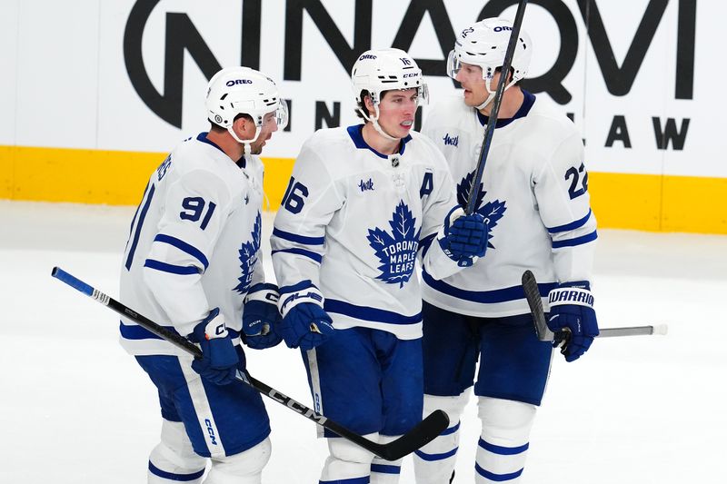 Mar 5, 2025; Las Vegas, Nevada, USA; Toronto Maple Leafs right wing Mitch Marner (16) celebrates with Toronto Maple Leafs center John Tavares (91) and Toronto Maple Leafs defenseman Jake McCabe (22) after scoring a goal against the Vegas Golden Knights during the third period at T-Mobile Arena. Mandatory Credit: Stephen R. Sylvanie-Imagn Images