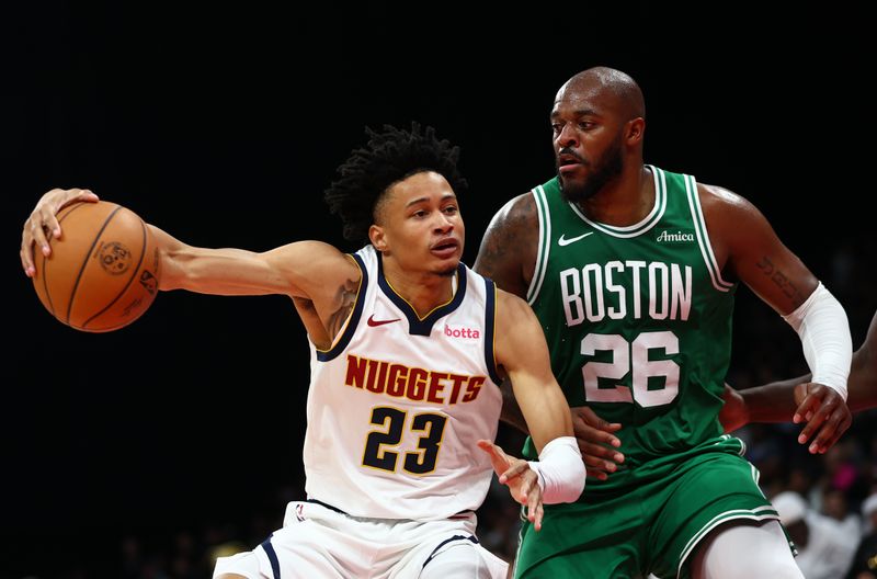 ABU DHABI, UNITED ARAB EMIRATES - OCTOBER 06: Trey Alexander of Denver Nuggets battles for the ball with Xavier Tillman Sr. of Boston Celtics during the NBA match between Boston Celtics  and Denver Nuggets at Etihad Arena on October 06, 2024 in Abu Dhabi, United Arab Emirates.  (Photo by Francois Nel/Getty Images)