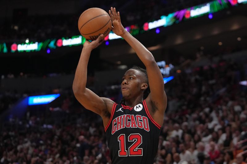 MIAMI, FL - APRIL 19: Ayo Dosunmu #12 of the Chicago Bulls shoots the ball during the game against the Miami Heat during the 2024 SoFi Play-In Tournament on April 19, 2024 at Kaseya Center in Miami, Florida. NOTE TO USER: User expressly acknowledges and agrees that, by downloading and or using this Photograph, user is consenting to the terms and conditions of the Getty Images License Agreement. Mandatory Copyright Notice: Copyright 2024 NBAE (Photo by Eric Espada/NBAE via Getty Images)