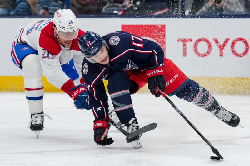 Nov 29, 2023; Columbus, Ohio, USA;  Columbus Blue Jackets right wing Justin Danforth (17) skates with the puck against Montreal Canadiens defenseman Johnathan Kovacevic (26) in the second period at Nationwide Arena. Mandatory Credit: Aaron Doster-USA TODAY Sports