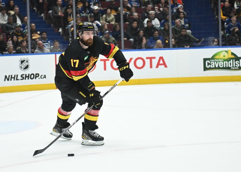 Mar 5, 2025; Vancouver, British Columbia, CAN; Vancouver Canucks defenseman Filip Hronek (17) skates with the puck during the third period against the Anaheim Ducks at Rogers Arena. Mandatory Credit: Simon Fearn-Imagn Images