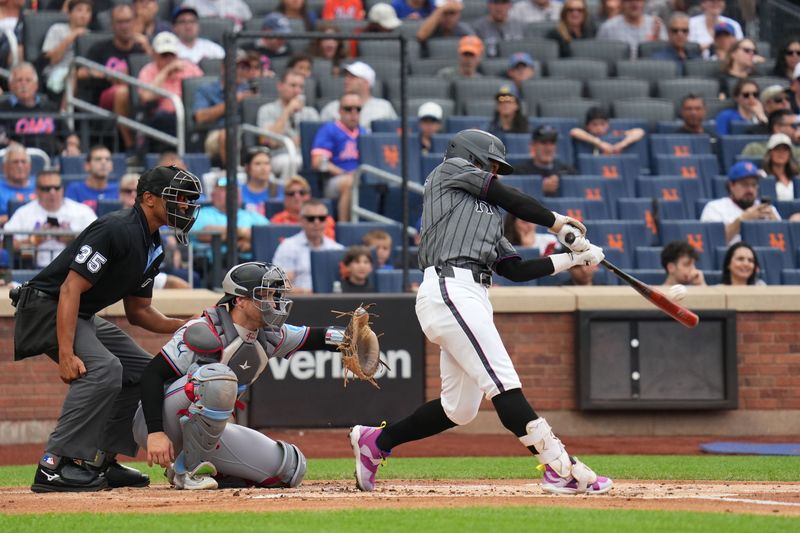 Aug 17, 2024; New York City, New York, USA; New York Mets shortstop Francisco Lindor (12) hits a home run during the first inning against the Miami Marlins at Citi Field. Mandatory Credit: Lucas Boland-USA TODAY Sports