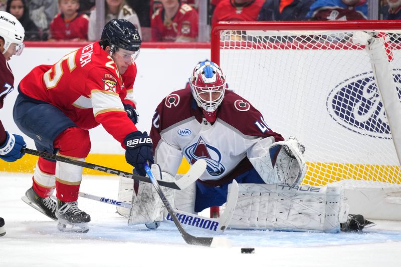 Nov 23, 2024; Sunrise, Florida, USA;  Colorado Avalanche goaltender Alexandar Georgiev (40) watches the puck slide wide of the reach of Florida Panthers right wing Mackie Samoskevich (25) in the second period at Amerant Bank Arena. Mandatory Credit: Jim Rassol-Imagn Images