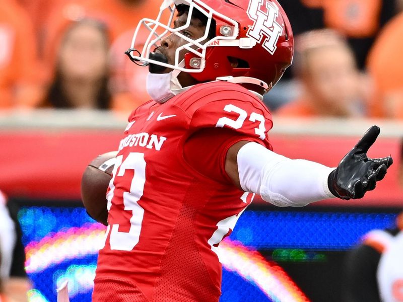 Nov 18, 2023; Houston, Texas, USA; Houston Cougars defensive back Isaiah Hamilton (23) reacts after his touch down during the first quarter against the Oklahoma State Cowboys at TDECU Stadium. Mandatory Credit: Maria Lysaker-USA TODAY Sports