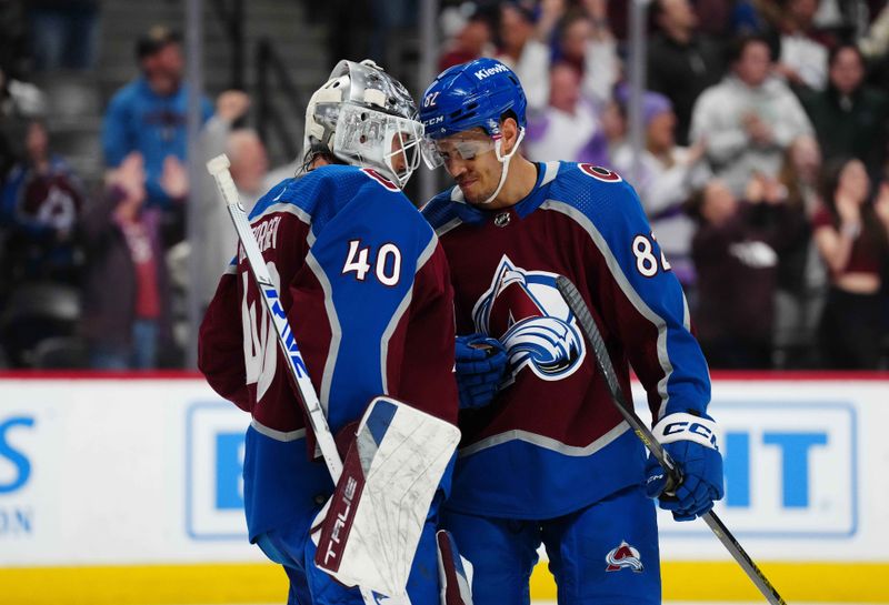 Nov 22, 2023; Denver, Colorado, USA; Colorado Avalanche goaltender Alexandar Georgiev (40) and defenseman Caleb Jones (82) celebrate defeating the Vancouver Canucks at Ball Arena. Mandatory Credit: Ron Chenoy-USA TODAY Sports