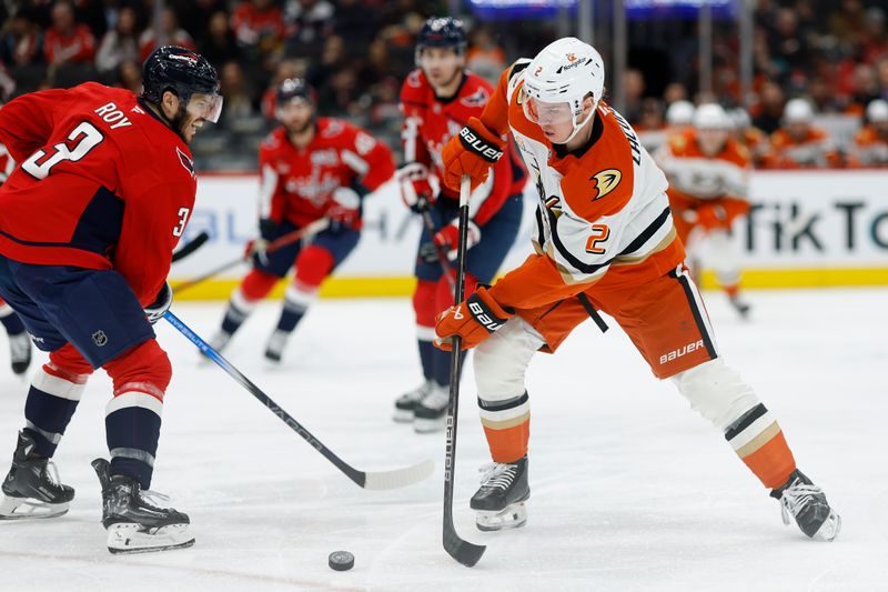 Jan 14, 2025; Washington, District of Columbia, USA; Anaheim Ducks defenseman Jackson LaCombe (2) skates with the puck as Washington Capitals defenseman Matt Roy (3) defends in the second period at Capital One Arena. Mandatory Credit: Geoff Burke-Imagn Images