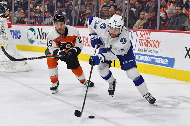 Feb 27, 2024; Philadelphia, Pennsylvania, USA; Tampa Bay Lightning left wing Brandon Hagel (38) carries the puck against Philadelphia Flyers right wing Garnet Hathaway (19) during the second period at Wells Fargo Center. Mandatory Credit: Eric Hartline-USA TODAY Sports