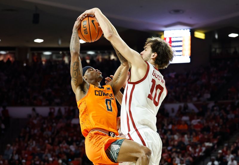 Feb 1, 2023; Norman, Oklahoma, USA; Oklahoma Sooners forward Sam Godwin (10) and Oklahoma State Cowboys guard Avery Anderson III (0) fight for control of the ball during the first half at Lloyd Noble Center. Mandatory Credit: Alonzo Adams-USA TODAY Sports