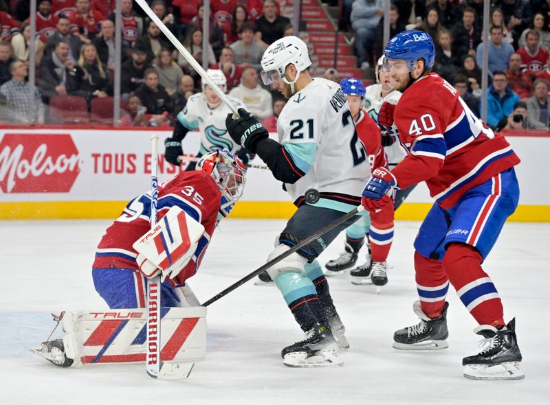 Dec 4, 2023; Montreal, Quebec, CAN; Montreal Canadiens goalie Sam Montembeault (35) stops Seattle Kraken forward Alex Wennberg (21) with teammate forward Joel Armia (40) during the first period at the Bell Centre. Mandatory Credit: Eric Bolte-USA TODAY Sports