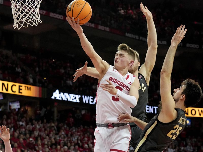 Mar. 2, 2023; Milwaukee, Wisconsin, USA; Wisconsin Badgers guard Connor Essegian (3) misses a basket while being defended by Purdue Boilermakers guard Ethan Morton (25) during the second half of their game at Kohl Center. Mandatory Credit: Mark Hoffman-USA TODAY Sports