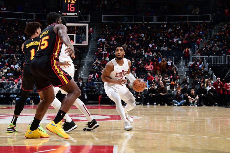 ATLANTA, GA - JANUARY 20: Donovan Mitchell #45 of the Cleveland Cavaliers drives to the basket during the game against the Atlanta Hawks on January 20, 2024 at State Farm Arena in Atlanta, Georgia.  NOTE TO USER: User expressly acknowledges and agrees that, by downloading and/or using this Photograph, user is consenting to the terms and conditions of the Getty Images License Agreement. Mandatory Copyright Notice: Copyright 2024 NBAE (Photo by Scott Cunningham/NBAE via Getty Images)