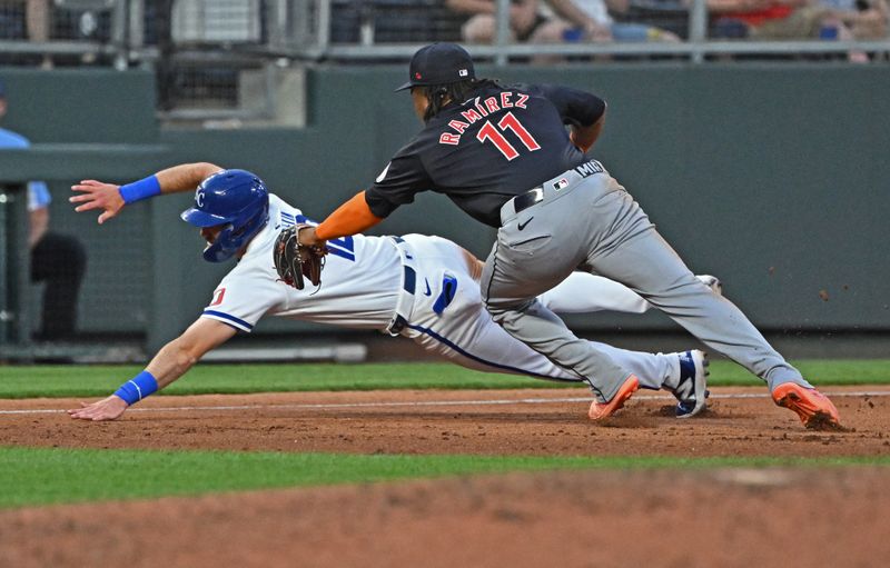 Jun 27, 2024; Kansas City, Missouri, USA; Kansas City Royals third baseman Nick Loftin (12) dives for third base against Cleveland Guardians third baseman Jose Ramirez (11) in the fifth inning at Kauffman Stadium. Mandatory Credit: Peter Aiken-USA TODAY Sports