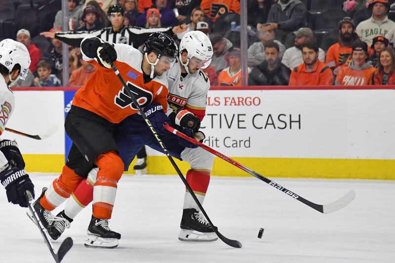 Mar 24, 2024; Philadelphia, Pennsylvania, USA; Philadelphia Flyers center Scott Laughton (21) and Florida Panthers defenseman Josh Mahura (28) battle for the puck during the first period at Wells Fargo Center. Mandatory Credit: Eric Hartline-USA TODAY Sports