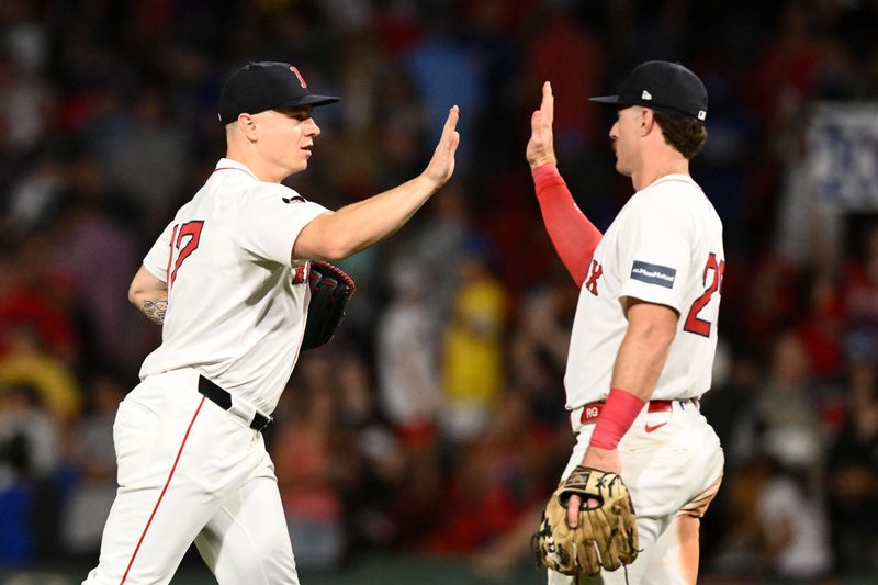 Aug 27, 2024; Boston, Massachusetts, USA; Boston Red Sox left fielder Tyler O'Neill (17) high-fives first baseman Romy Gonzalez (23) after a game against the Toronto Blue Jays at Fenway Park. Mandatory Credit: Brian Fluharty-USA TODAY Sports