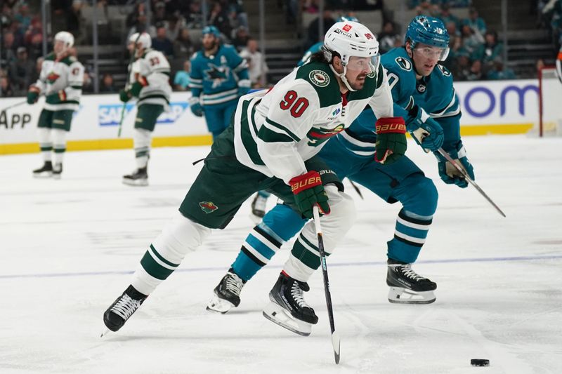 Apr 13, 2024; San Jose, California, USA; Minnesota Wild center Marcus Johansson (90) controls the puck against San Jose Sharks center Klim Kostin (10) during the first period at SAP Center at San Jose. Mandatory Credit: David Gonzales-USA TODAY Sports