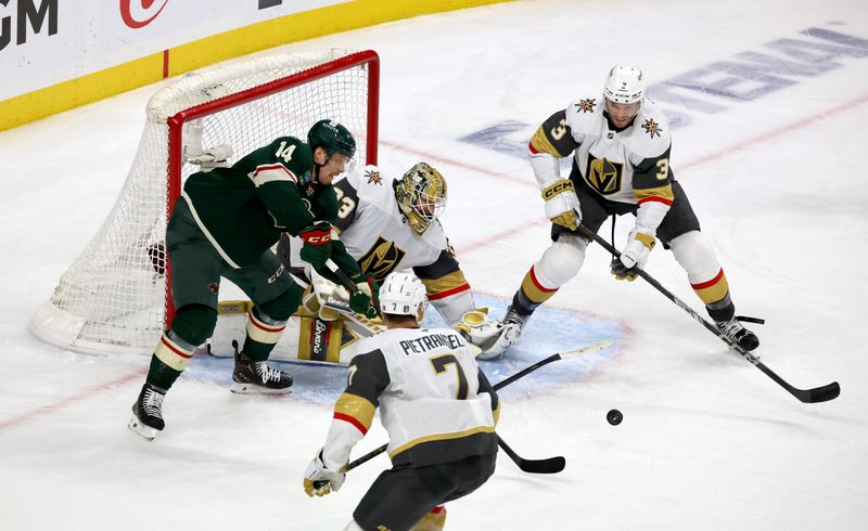 Apr 26, 2025; Saint Paul, Minnesota, USA; Minnesota Wild center Joel Eriksson Ek (14) looks for a loose puck in front of Vegas Golden Knights goaltender Adin Hill (33) during 1st OT in game four of the first round of the 2025 Stanley Cup Playoffs at Xcel Energy Center. Mandatory Credit: Bruce Fedyck-Imagn Images