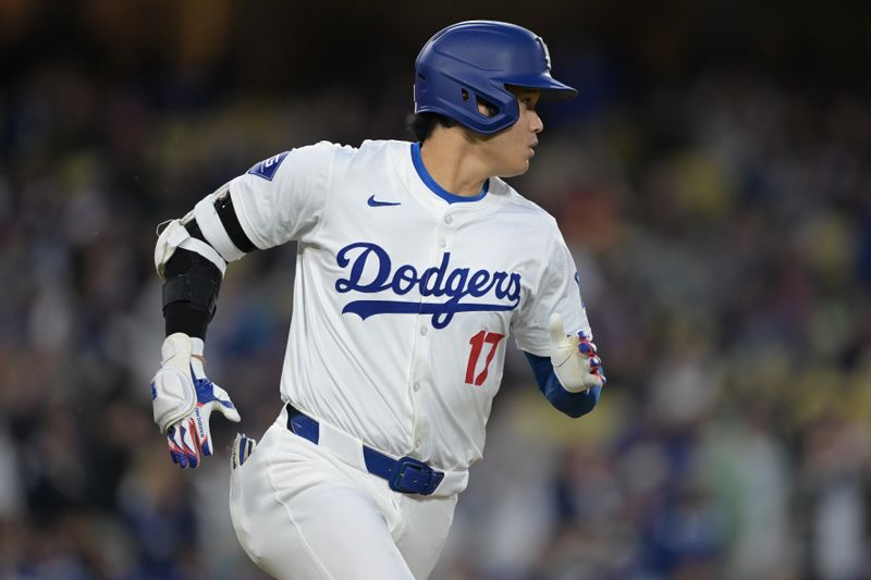 Apr 14, 2024; Los Angeles, California, USA; Los Angeles Dodgers designated hitter Shohei Ohtani (17) singles in the eighth inning against the San Diego Padres at Dodger Stadium. Mandatory Credit: Jayne Kamin-Oncea-USA TODAY Sports