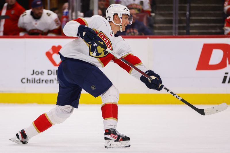 Mar 21, 2024; Sunrise, Florida, USA; Florida Panthers defenseman Gustav Forsling (42) shoots the puck against the Nashville Predators during the second period at Amerant Bank Arena. Mandatory Credit: Sam Navarro-USA TODAY Sports