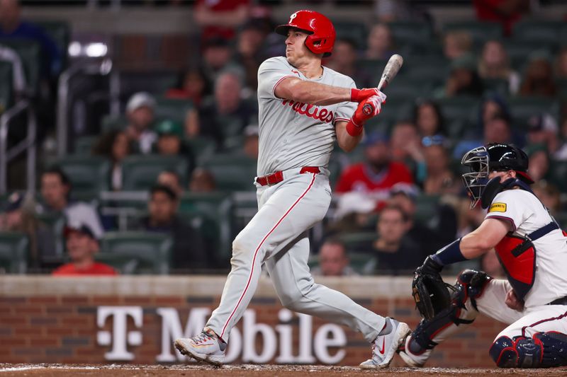 Apr 10, 2025; Atlanta, Georgia, USA; Philadelphia Phillies catcher J.T. Realmuto (10) hits a single against the Atlanta Braves in the sixth inning at Truist Park. Mandatory Credit: Brett Davis-Imagn Images