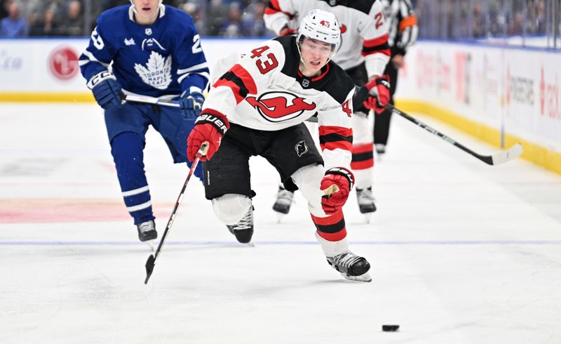 Apr 11, 2024; Toronto, Ontario, CAN; New Jersey Devils defenseman Luke Hughes (43) pursues the puck against the Toronto Maple Leafs in the second period at Scotiabank Arena. Mandatory Credit: Dan Hamilton-USA TODAY Sports