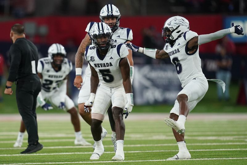 Sep 30, 2023; Fresno, California, USA; Nevada Wolf Pack defensive back Emany Johnson (5) reacts next to defensive back Jaden Dedman (6) after intercepting a pass against the Fresno State Bulldogs in the third quarter at Valley Children's Stadium. Mandatory Credit: Cary Edmondson-USA TODAY Sports