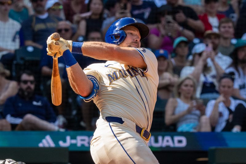 Aug 24, 2025; Seattle, Washington, USA; Seattle Mariners catcher Cal Raleigh (29) hits a single during the eighth inning against the Athletics at T-Mobile Park. Mandatory Credit: Stephen Brashear-Imagn Images