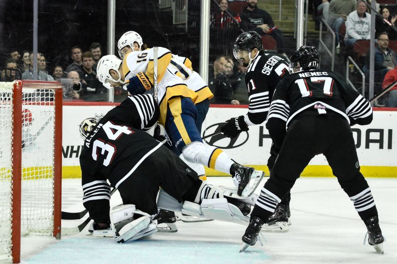 Apr 7, 2024; Newark, New Jersey, USA; New Jersey Devils goaltender Jake Allen (34) and Nashville Predators left wing Jason Zucker (16) collide during the third period at Prudential Center. Mandatory Credit: John Jones-USA TODAY Sports